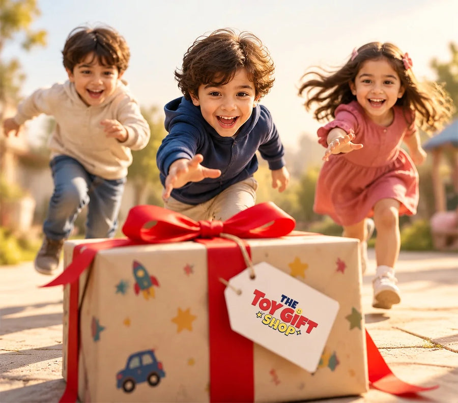 Three children running towards a gift wrapped in paper and a red ribbon, with a Toy Gift Shop tag