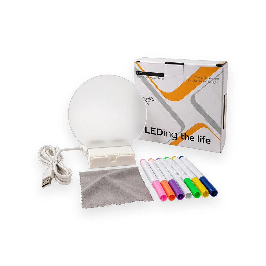 Round acrylic message lamp on its base with seven colour markers, a cloth and a USB cable