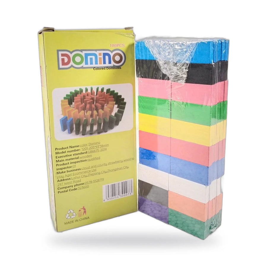 Stack of colourful plastic domino blocks next to their box