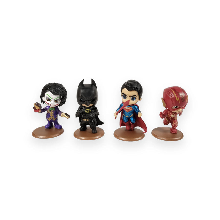 Four chibi-style Justice League figures on round bases in front of their packaging box