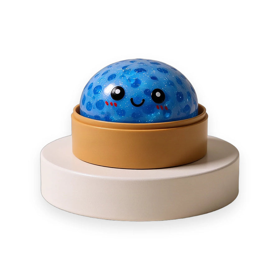 Glitter squishy dumpling with a smiling face sitting in its steamer-style case