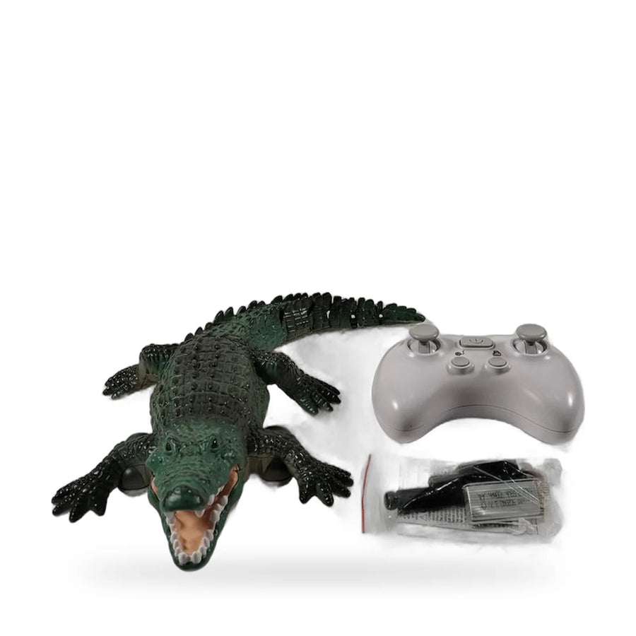 Remote control swimming crocodile toy with its controller on a white surface